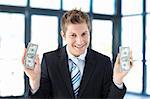 Young businessman holding money in office