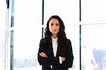 Confident businesswoman with folded arms in office