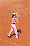 Girl playing tennis outdoor on court