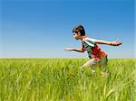 a boy is running in the field