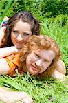 Portrait of a man and woman lying in the grass