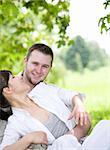 happy young couple relaxing in park