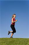 Sporty young woman running on the nature