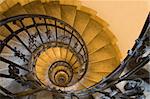 Spiral staircase, forged handrail and stone steps in old tower