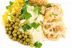 Close-up of meatballs, potatoes, verdure, peas and corn dish