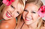 Beautiful Smiling Girls with Hibiscus Flowers in Their Hair.