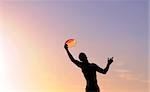 silhouette of a man catching a frisbee