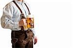Bavarian man dressed with original leather trousers holds an Oktoberfest beer stein into the camera