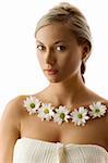 beauty portrait of a beautiful woman with twist braid and necklace of white daisy