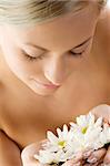 beauty portrait of a beautiful woman with twist braid and some white daisy