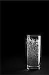 Glass of mineral water is isolated against a black background