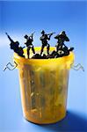 Toy soldiers row on the trash, end of war metaphor, peace