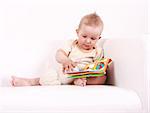 Portrait of cute baby reading a picture book