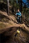 Woman backpacker goes on footpath on the dackground is unfocused.