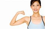 A pretty asian girl flexes one arm on white background