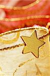 Christmas golden decoration with gold star over red background