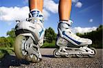 Inline skates in action closeup. Shallow depth of field, focus on left skate.