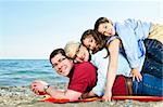 Portrait of a happy family having fun on a beach