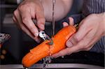 Peeling a carrot in a modern kitchen