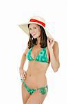 Beautiful and sexy Caucasian waman in a green bikini wearing a hat