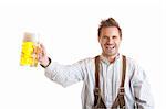 Bavarian Man dressed with traditional leather trousers (lederhose) holding Oktoberfest Beer Stein (Mass)