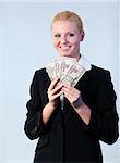 Young attractive Business woman holding dollars to the camera