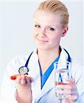 Doctor holding pills to camera with focus on the person