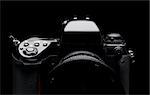 Professional digital camera over black background.