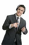 Handsome businessman dancing hearing music with headphones