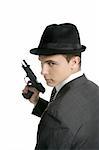 Classic mafia portrait, man with black suit and gun, isolated on white