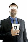 Blindfolded businessman with target over white background, conceptual image
