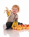 Baby with fruits isolated on white.