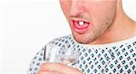 Close-up of a young patient with a pill in his mouth