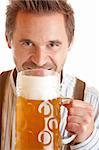 closeup of an Bavarian man which wants to drink out of Oktoberfest beer stein