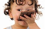 Child eats chokolate,isolated on a white background.