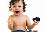 Child eats chocolate, isolated on a white background.