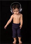 Dancing baby with headphones, on a black background.
