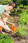 Mother and her little daughter doing gardening
