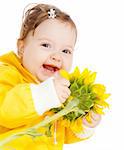 Portrait of a laughing baby with sunflower in hands
