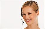 close up of businesswoman with headset on and white seamless background