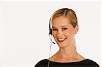 businesswoman with headset on and white seamless background