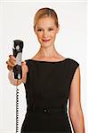 businesswoman holding up business phone with cord