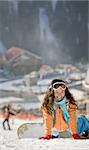 Lucky girl snowboarder in a mountain valley