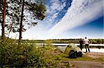 A couple camping on a lake landscape