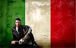 italian soccer player sitting against a italian flag background