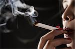 Woman smoking on dark area