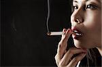 Woman smoking on dark area