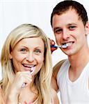 Portrait of a couple cleaning their teeth in bathroom