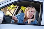 Concerned Blonde Woman Using Cell Phone While Driving.