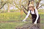 Young woman cleaning tree limbs